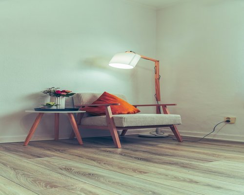 A warmly lit reading corner with a comfortable chair and a small lamp